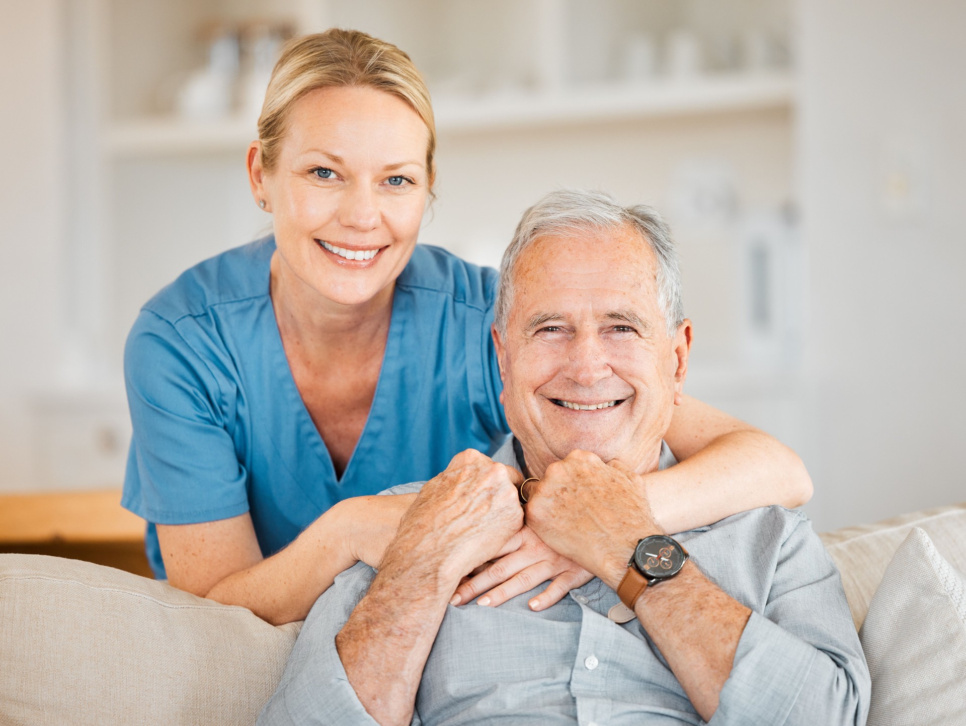 Portrait of a nurse caring for a senior man at home