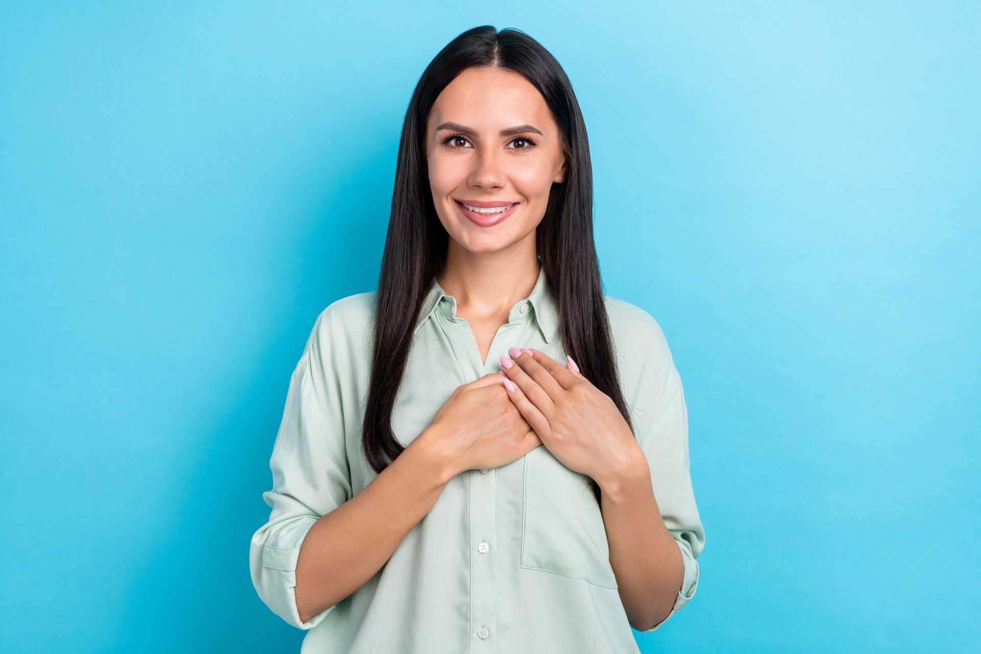 Portrait of smiling winsome lady touch chest appreciate sign wear pastel shirt isolated on blue color background